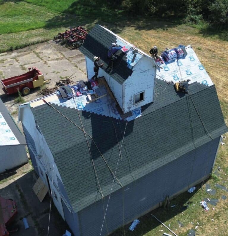Rainforcing Roofing & Exteriors expert performing a detailed roof inspection to identify storm damage.