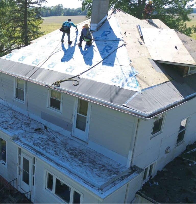 A pristine, newly installed roof featuring code-compliant flashing and ridge vents for maximum protection.